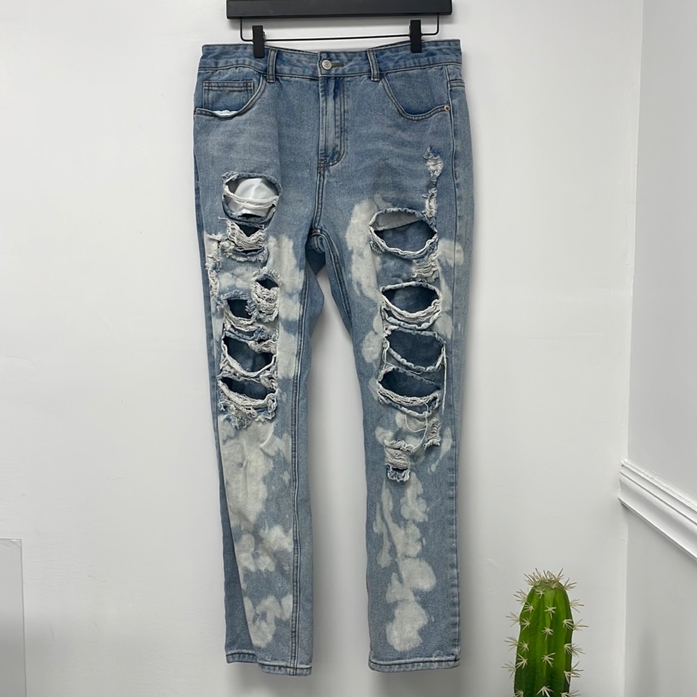 Denim blue jeans with distressing and bleach splattered